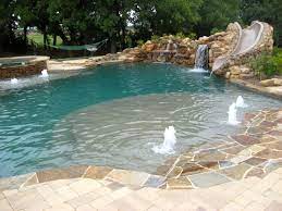 Dolce Pools Design Consists Of Elevated Spa Extended Tanning Ledge With Water Bubble Jets Rock Based Wat Swimming Pool Designs Pool Patio Cool Swimming Pools