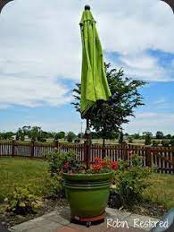Diy Planter Umbrella Stand 5 Gallon Bucket With Concrete Inside A Decorative Planter On A Rolli Outdoor Umbrella Stand Patio Umbrella Stand Outdoor Umbrella