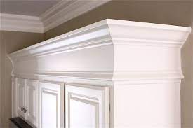 The Yellow Cape Cod Making Cabinets Taller Builder Cabinets Go Custom With Molding Builders Cabinets Home Cabinet Molding