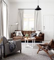 Clean White Walls Chic Ways To Style A Brown Sofa In Your Living Room Brown Living Room Decor Brown Living Room Living Room Grey