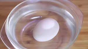 tell if eggs are raw or hard boiled