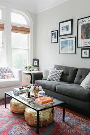 Living Room Light Gray Walls Dark Gray Couch Pops Of Color Poufs Under The Coffee Table Eclectic Living Room Eclectic Living Room Design Home Decor