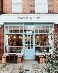 Cute Brick Exterior With Pale Turquoise Door And Windows Storefront Design Cafe Exterior Brick Store