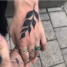 Simple Black Branch With Leaves Tattooed On The Left Hand Hand Tattoos Tribal Hand Tattoos Rose Tattoos For Men