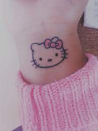 Hello kitty tattoo with the hair dryer and scissors but no music notes and she'd be wearing a frilly little apron. Hello Kitty Tattoo Shared By Ikattie On We Heart It