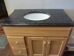 bathrooms with a granite vanity top