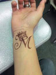 Wrist Tattoo Letter M With A Crown Crown Means Self Control A Reminder To Use Power Wisely Henna Tattoo Designs Alphabet Tattoo Designs Tattoo Lettering