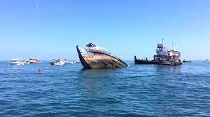 ship and tugboat sinking in ocean off