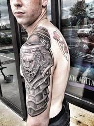 Again Wolf Instead Of The Lion And Less Evil Looking Maoritattoos Shoulder Armor Tattoo Armor Tattoo Cool Arm Tattoos
