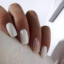 One nail has a super cute bunny and one nail has a pastel floral design. Accurate Nails Cute Fashion Nails Delicate Wedding Nails Long Nails Nails For Wedding Dress Plain White Nails Wedding Nai Nails Fashion Nails Bride Nails