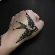 Black Swallow Tattoo On The Left Hand Hand Tattoos For Guys Hand Tattoos Traditional Tattoo Man