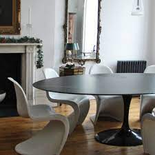 His pedestal tables (which came in dining, coffee, and side sizes) were topped with thin, round or oval surfaces wider than their base. Knoll Saarinen Oval Tulip Black Marble Dining Table Material Life Co Uk Oval Dining Room Table Saarinen Oval Dining Table Oval Table Dining