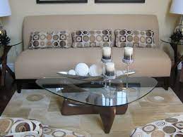 This centerpiece is made from a slice of a walnut log. Glass Candles Holders As Centerpiece For Coffee Tables