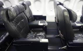 The seats of the 1st row have less space for passengers' legs because of. United First Class 737 Flight Review I One Mile At A Time