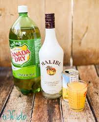 Malibu is based on rectified white barbados rum blended with natural coconut extracts and presented in a iconic opaque white bottle with the palm tree logo. Ginger Ale Malibu Coconut Rum And Pineapple Displayed On A Warm Brown Wooden Backdrop Summer Rum Cocktails Rum Drinks Recipes Drinks