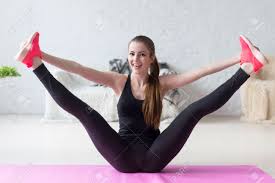 Funny Smiling Girl Holding Legs Apart Doing Exercises Aerobics Warming Up  With Gymnastics For Flexibility Leg Stretching Workout At Home Fitness  Stock Photo, Picture And Royalty Free Image. Image 40160419.