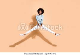 Photo portrait of african american woman jumping up holding hands down with spread  legs open mouth isolated on pastel beige | CanStock