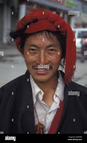 friendly smiling Tibetan khampa man pilgrim Lhasa street red hair braid  braiding costume ethnic Tibet Autonomous Region China Stock Photo - Alamy