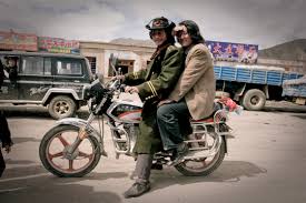 Purchase digital downloads and a range of printed products of James Gritz's  image - Two khampa men on Motorcycle, Nangchen, Tibet