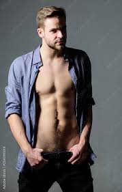 Feeling flirty. Man handsome sexy hipster undressing. Guy sexy muscular  body take off clothes grey background. Full desire. Seductive macho feeling  sexy. Bohemian sexy body. Object of desire concept Stock Photo |