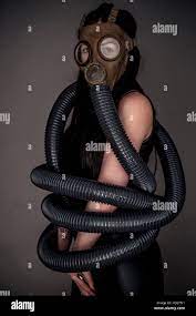 Sexual fantasies and perversion: gas mask fetish photography - studio  portraits - a woman wearing a gas mask entwined in coils of rubber hose -  UK Stock Photo - Alamy