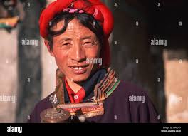 Caption: Tagong, Sichuan, China - Apr 2001. A Khampa man in the former  Tibetan kingdom of Kham. Khampa men are identified by vibrant head bands of  red Stock Photo - Alamy