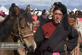 Khampa man & Tibetan pony wait for a chance to race at the Litang Horse  Festival - Kham, Sichuan Province, China, (Tibet) - SuperStock
