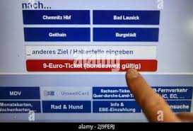 Leipzig, Germany. 23rd May, 2022. A woman buys a 9-euro ticket from a  Deutsche Bahn (DB) ticket vending machine at Leipzig Central Station.  People in Saxony will be able to buy the