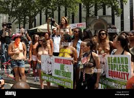 New York City. 23rd Aug, 2015. Women bare their naked chest as they  participate in the GoTopless pride parade in Manhattan August 23, 2015 in  New York City. The GoTopless group fights