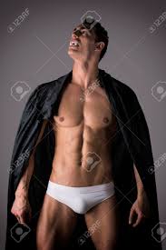 Naked Muscular Fit Young Man In Briefs Posing As A Vampire Or Dracula In A  Black Cloak Stock Photo, Picture And Royalty Free Image. Image 30804625.