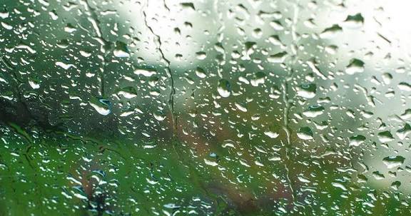 Dew forming on slanted glass panel at dawn