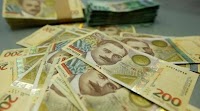 Lari closes higher against US dollar