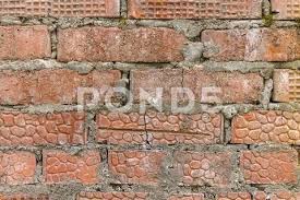 Wall Of Old Red Brick And Gray Cement
