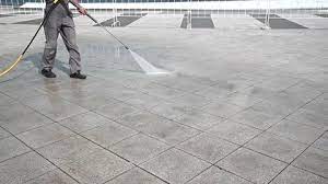 Man Cleaner Washes Paving Slabs In The