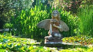Wooden Sculpture Of A Fairy In A Pond