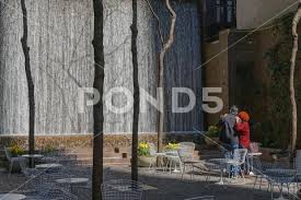 Man And Woman Watching The Waterfall In