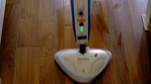 A Man Is Washing The Floors With Steam