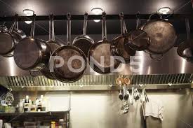 Pans Hanging In Commercial Kitchen