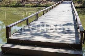 Small Wooden Bridge Across The Lake
