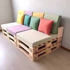 A Wooden Pallet Couch With A Cushion