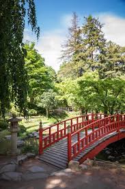 Red Wooden Bridge On A Japanese Garden Pond