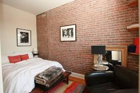 Narrow Bedroom With Exposed Brick Wall