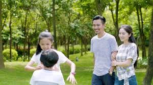 Asian Family Of 4 Walking Laughing In
