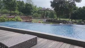 A Pool With A Wooden Deck And Outdoor