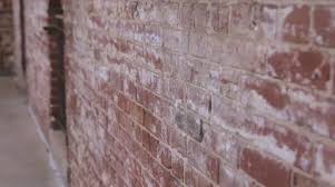 Worn Brick Wall On Building Exterio