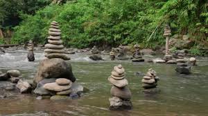 Stone Towers On River Rocks In Summer