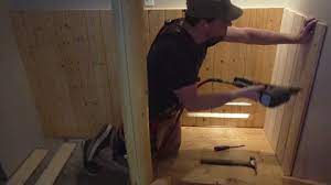Carpenter Installing Wood Paneling In