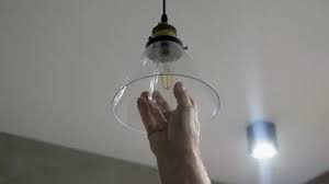 Worker Change A Lamp In A Suspended Sc