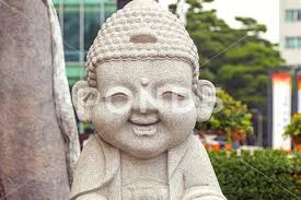 Smiling Stone Buddha Statue At The