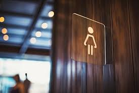 Blurred Wooden Sign With Toilet Icon